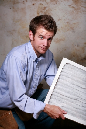 Technician holding a furnace filters